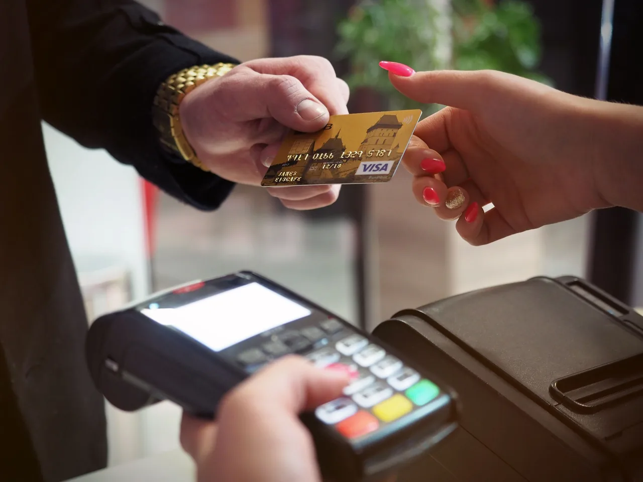Close-up of a credit card payment being processed at a POS terminal
