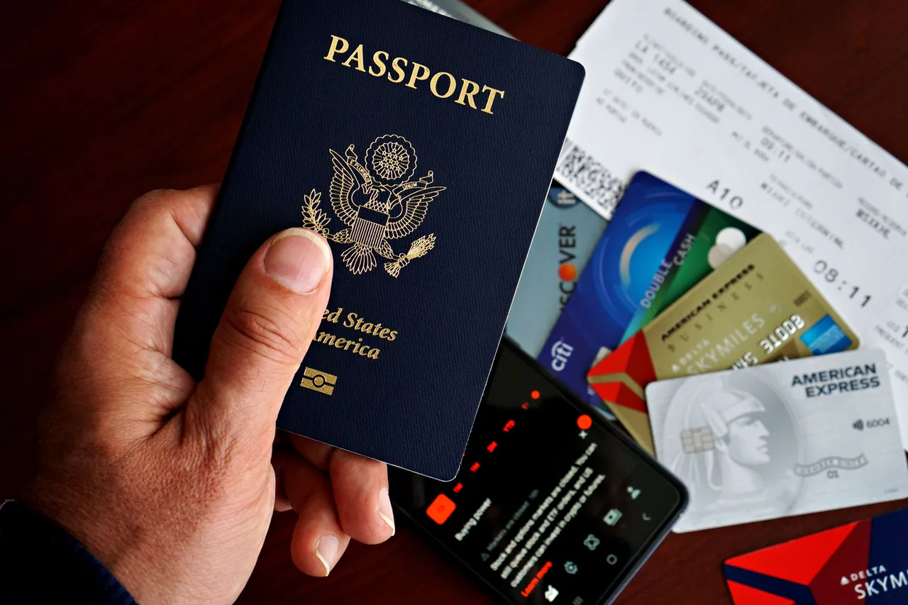 US passport with credit cards and travel documents on a table, travel preparation concept