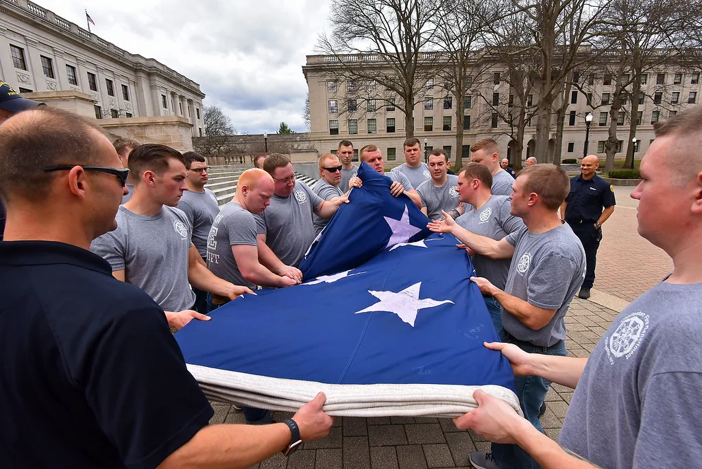 Service members ceremonially folding the American flag