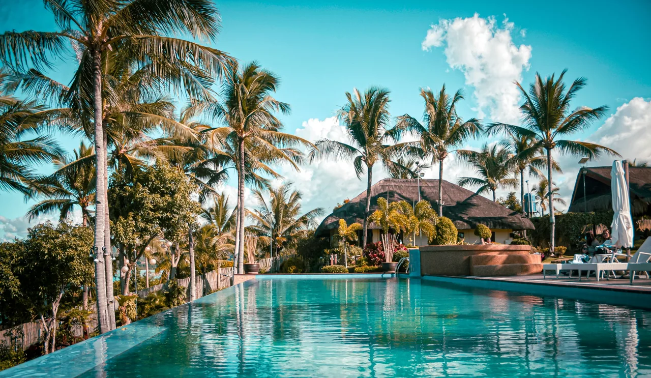 Scenic view of a luxury tropical resort with palm trees and an inviting pool