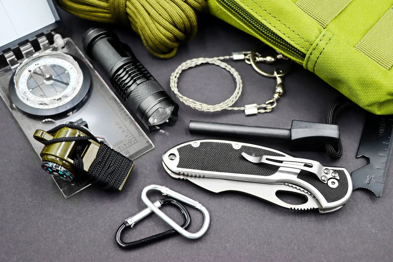 A comprehensive layout of essential survival tools including compass, flashlight, and knife, perfect for outdoor adventures