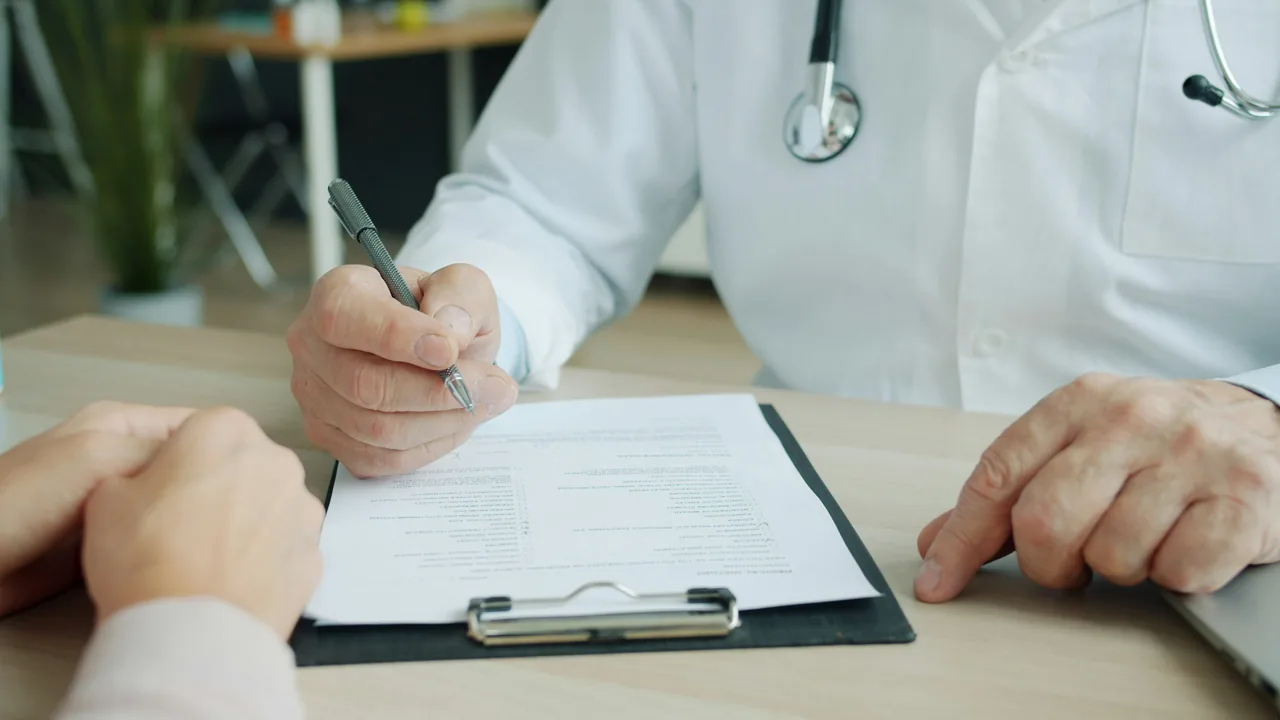 Medic in uniform is ticking symptoms in patient's medical records during appointment in clinic talking to patient sick woman. People and healthcare concept
