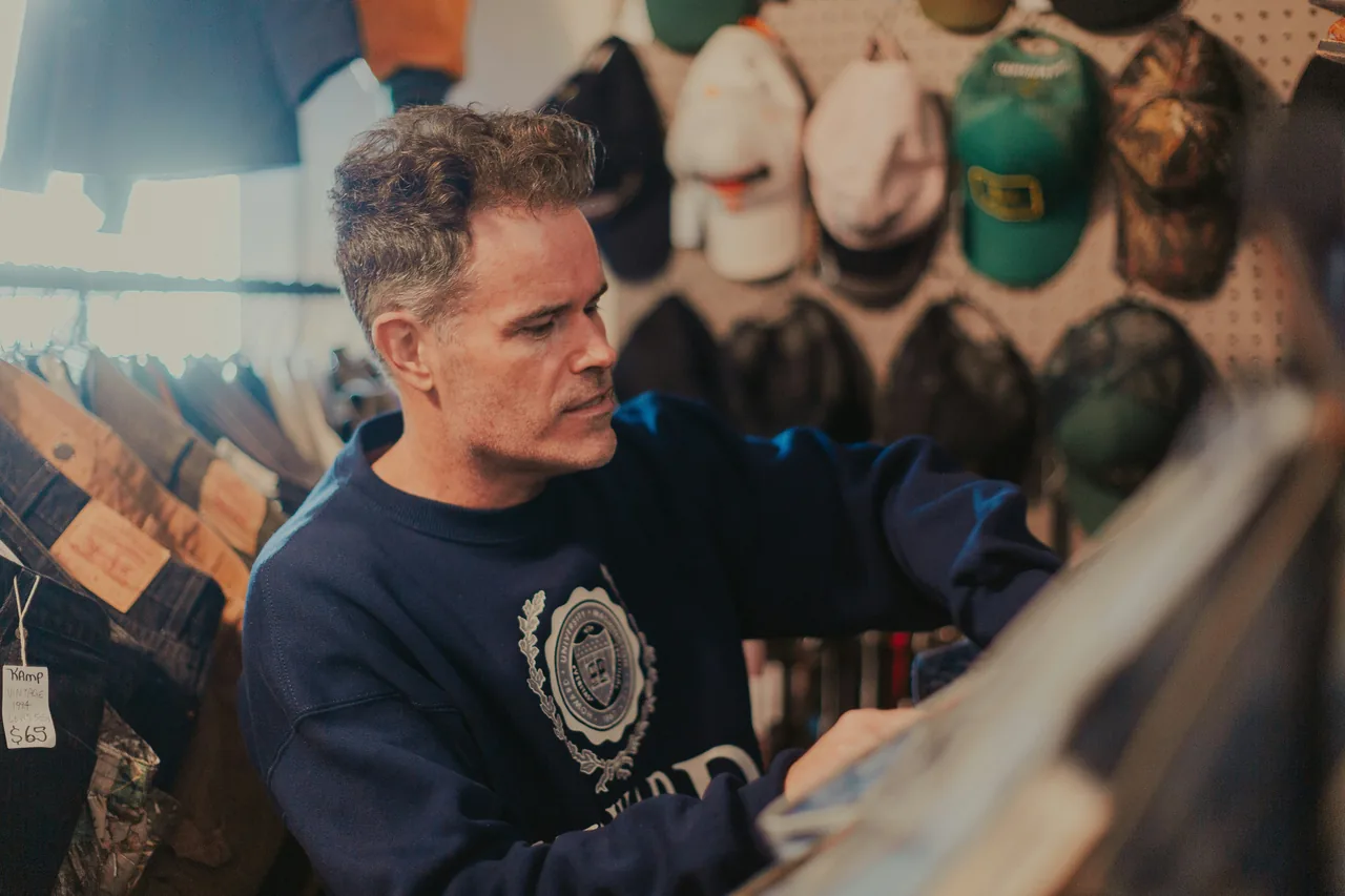 A man is looking at items in a store